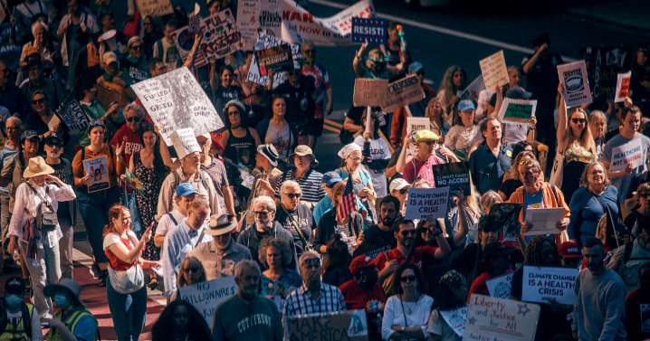 Marchers gather in worldwide protest of financial institutions 'profiting off the climate crisis'