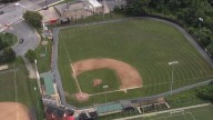 Firefighters charged after spraying baseball field with water hose