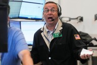 Stocks tick higher as Wall Street drifts near its record levels