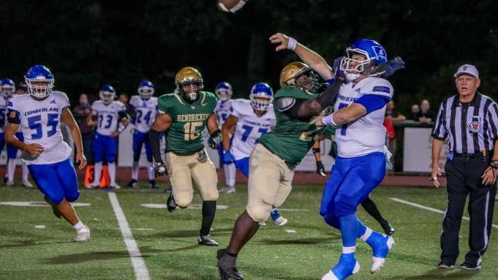 Hendricken rolls past Cumberland In High School Football.