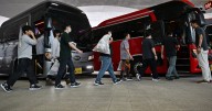 South Koreans detained in U.S. immigration raid arrive back home to applause and protests