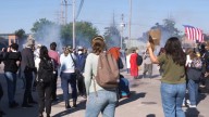 Federal agents fire chemicals as protesters try to block car at immigration site outside Chicago