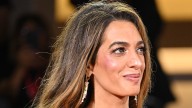 Amal Clooney flies under the radar in 'refined' trench with tumbling caramel locks