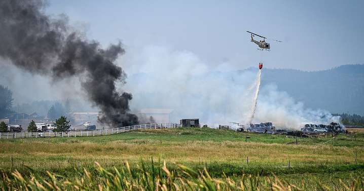 Crews work to extinguish ignited hay bales in grass fire west of Kalispell