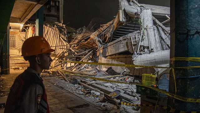 Rescuers run oxygen to survivors in Indonesia school building collapse that buried dozens