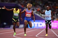 Athletics-Lyles surges late to win fourth successive 200m gold