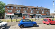 Man taken to hospital after stabbing outside row of shops