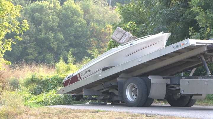Abandoned boat found wedged under Fargo pedestrian bridge