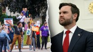 Protesters heckle JD Vance as he pays respects to Catholic school shooting victims
