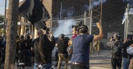 Three protesters arrested as demonstrators block vehicle at key immigration building near Chicago
