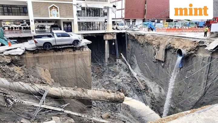 Massive sinkhole opens in Bangkok, swallows cars & power poles