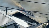 Ten fire crews battle fierce flames after a two-storey home in Brisbane’s inner east was engulfed