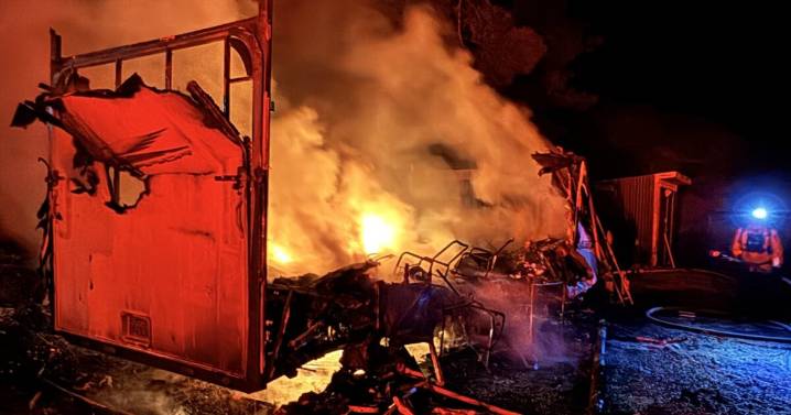 Travel trailer erupts in flames, causes small vegetation fire