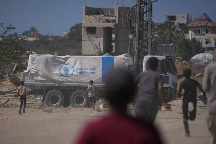 Aid trucks roll into Gaza as Hamas hands over more bodies 