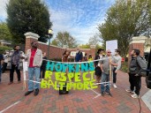 Protestors tell Johns Hopkins University to 'give the city back!'