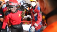 Rescuers chip away debris with hand tools to save those trapped in Indonesia school collapse