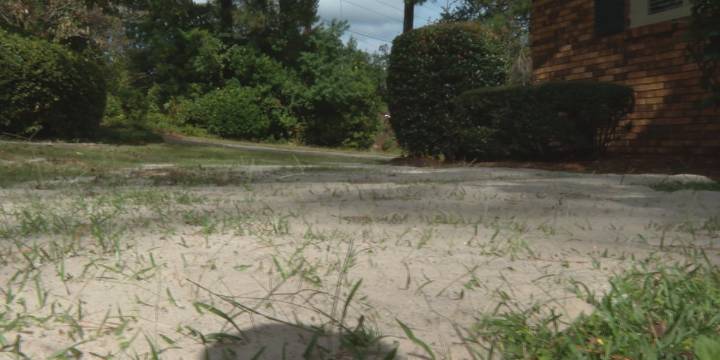 Columbia woman calls for cleanup after construction leaves yard covered in sand