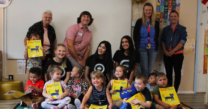 Volunteers foster literacy by reading to children and giving them books