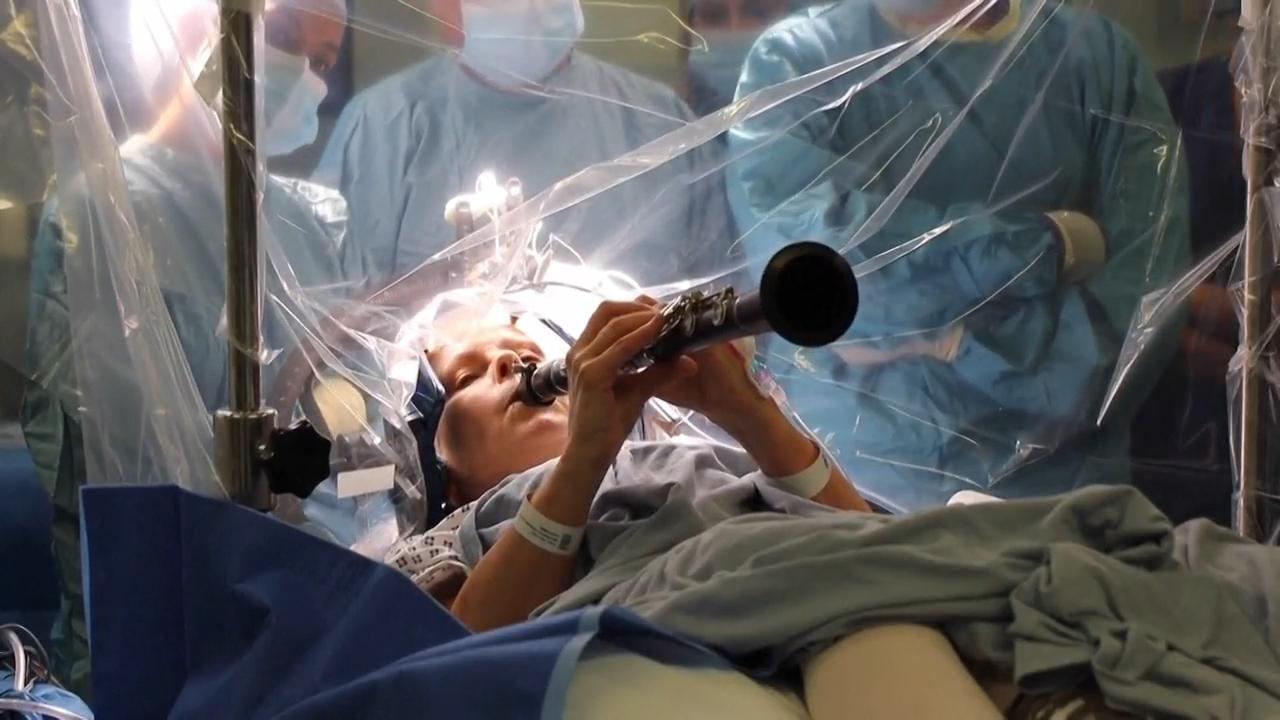 Patient with Parkinson's disease plays clarinet during brain procedure at London hospital