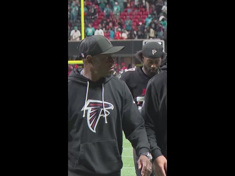 Raheem Morris walks off the field after a 34-10 loss to the Dolphins