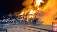 Semi hauling vehicles burst into flames overnight on I