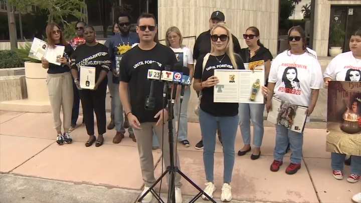 Families of gun violence victims gather at Sen. Rick Scott’s Coral Gables office to demand action