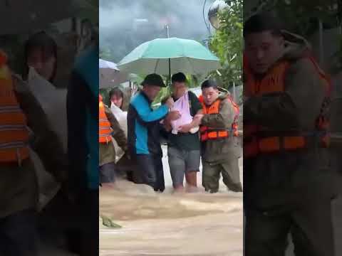 Newborn Baby Carried Through Floodwaters as Typhoon Batters Vietnam #shorts