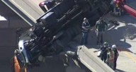 Tow truck dangles off overpass in dramatic crash
