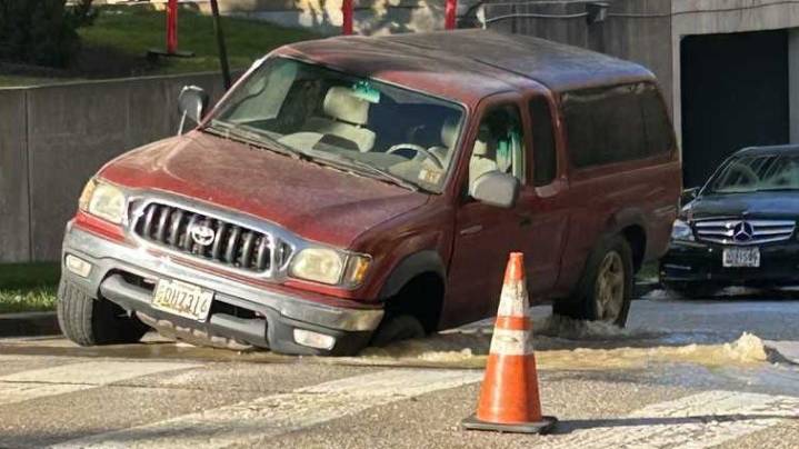 DPW: Pickup truck crashes into sinkhole near water main break in North Baltimore