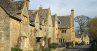 Little-known Cotswolds village with ancient church, thatched cottages and stunning manor house