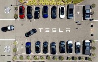 Parents of college student killed in Tesla crash say design flaw in door trapped her as car burned
