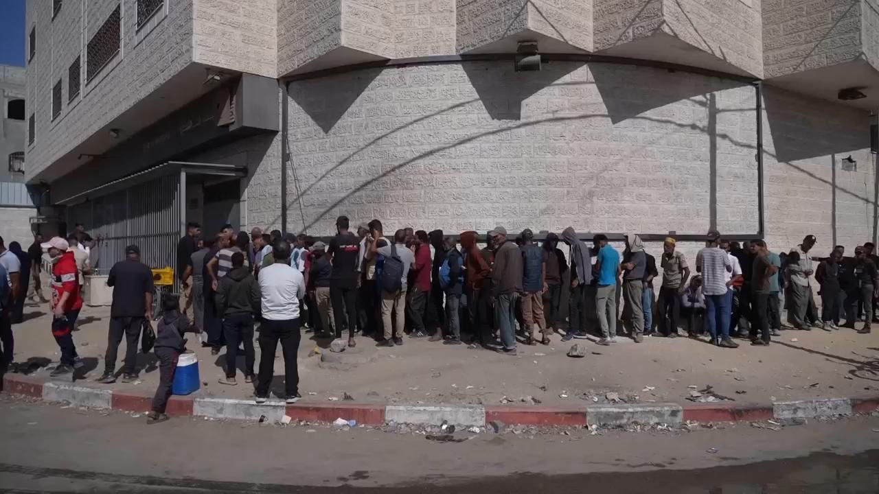 Palestinians wait in long lines at reopened Gaza bank but left disappointed by lack of cash
