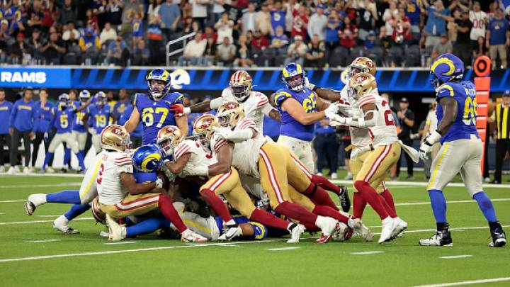 Short-handed 49ers stop Rams on downs in overtime, preserving a 26