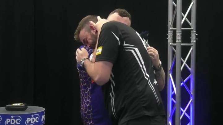 Emotional darts star consoled by opponent he beat in final of tournament