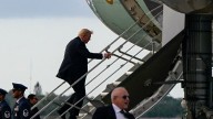 Trump boards Air Force One using small stairs after sniper nest found near airport