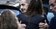 Former French president Nicolas Sarkozy hugs supermodel wife before going into prison