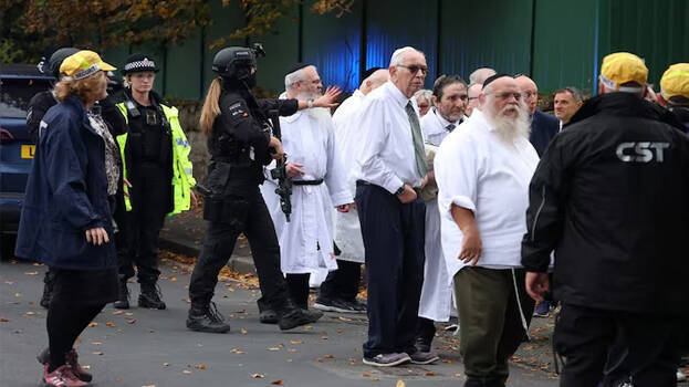 Man drives car into crowd outside Jewish synagogue in Manchester, stabs two to death; attacker shot dead by police