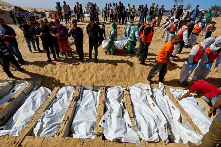 Mass funeral in Gaza as signs of alleged abuse reported on bodies returned by Israel