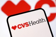 CVS raises full-year forecast, takes $5.7 billion impairment charge on health clinics