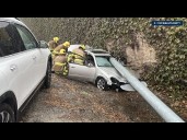 Car flattened by light pole after crashing on slick roads
