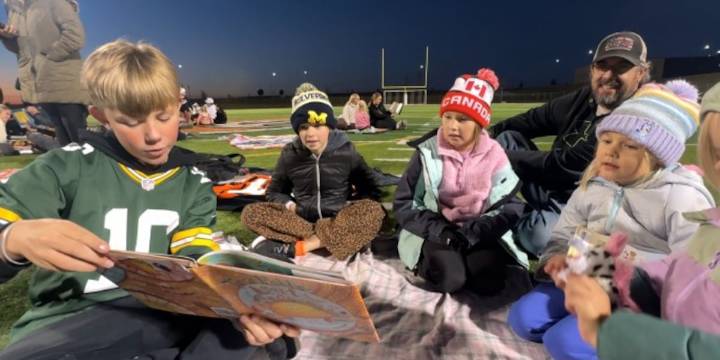 “Literacy under the lights,” Williston student-athletes promote reading with younger kids