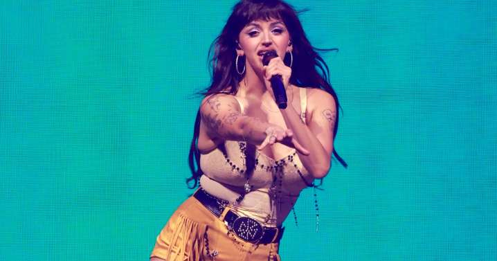 Katy Perry Twirls in Hawaiian Skirt & Animal-Print Corset Top in Concert Photos