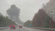 Smoke billows over I-195 after jet crash on a a Massachusetts highway