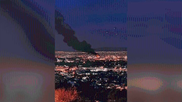 A panorama of Los Angeles at LAX has...a burning building in it?