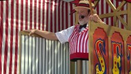 Midway Barker at State Fair of Texas has happily been stuck in one place