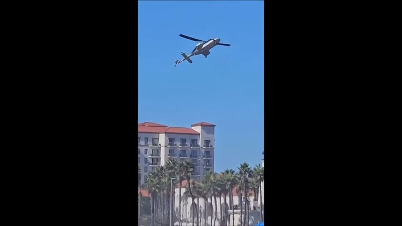 Southern California beachgoers watch helicopter spiral out of control, slam into palms