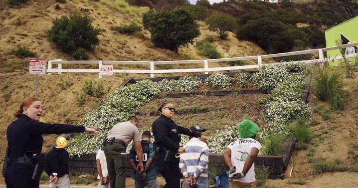 Six people who tried to hang a banner on the Hollywood sign are arrested, officials say