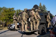 Noem visits Chicago area ICE facility as agents arrest 13, raid city neighborhoods
