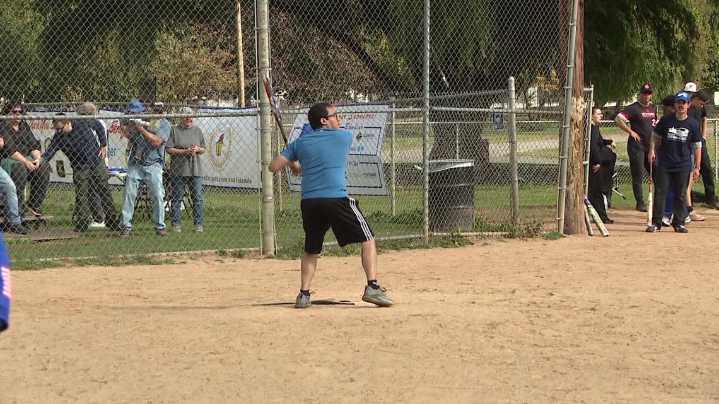 County and city employees face off in a softball game for charity