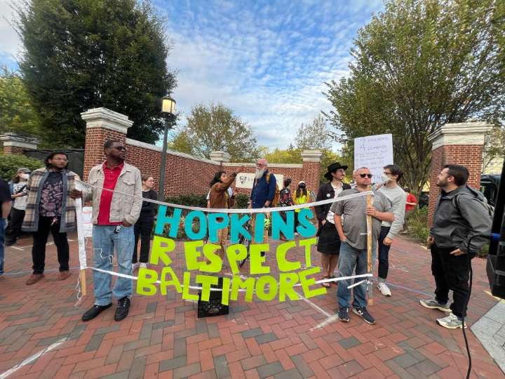 Protestors tell Johns Hopkins University to 'give the city back!'